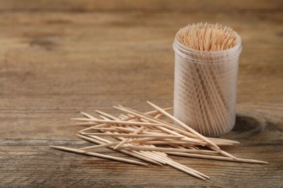 Toothpicks spilled next to their container